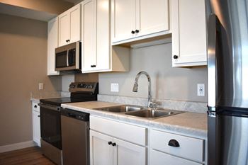 Modern kitchens with islands, white marble-look countertops and stainless steel appliances
